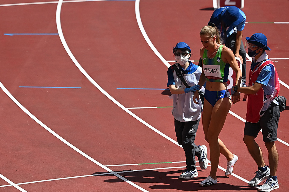 With the help of volunteers, Slovenian sprinter Anita Horvat exits the venue after the competition. Volunteers offered their assistance to athletes and Games personnel not just at the competition venues, but also at various locations around the country.  XINHUA/AFLO