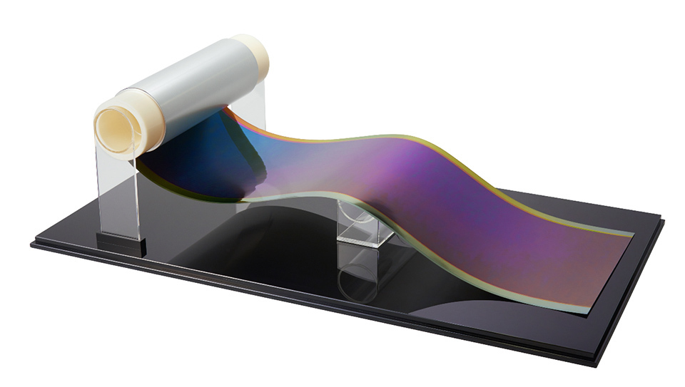 Image of a film solar cell being rolled.