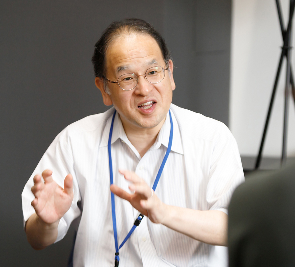 A man speaking while using hand gestures.