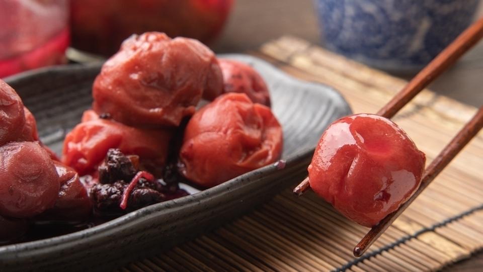 A delectable Japanese umeboshi served with chopsticks, showcasing the rich culinary heritage of Japan.