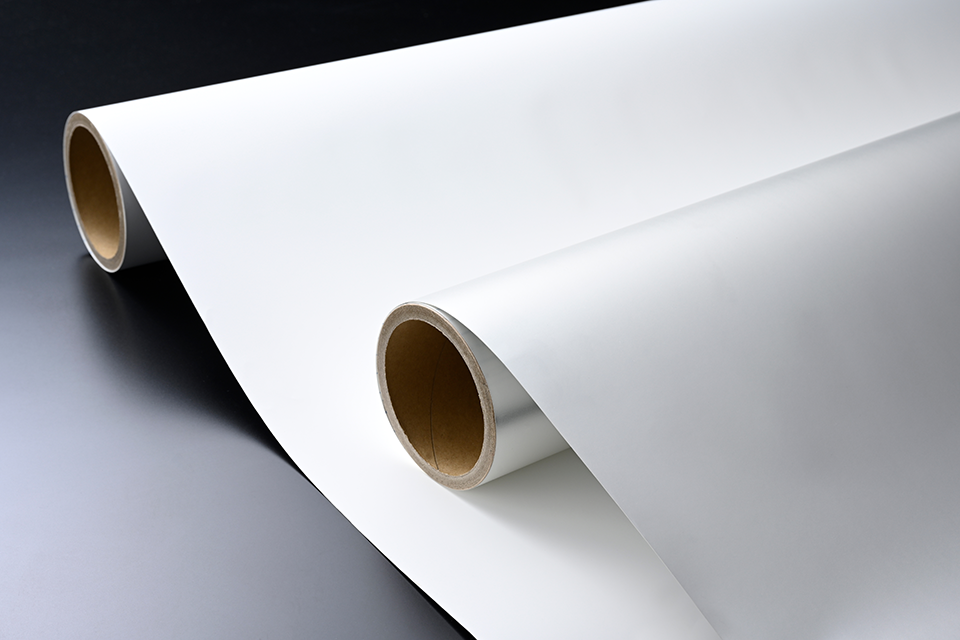 Two rolls of white membrane on a black background.