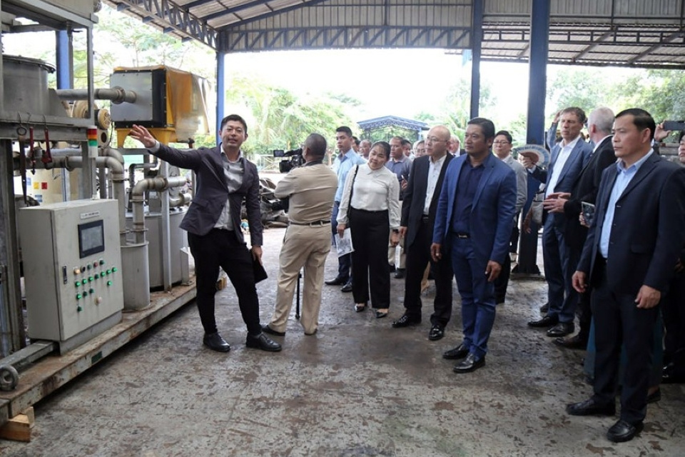 A group of officials listening to an explanation at a waste management site