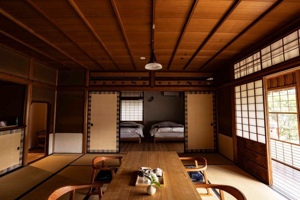 A traditional Japanese room with wooden cieling, washi paper windows and an elegant table