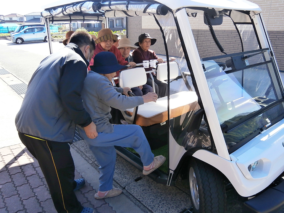 Older passengers making use of an electric golf cart in Himeshima