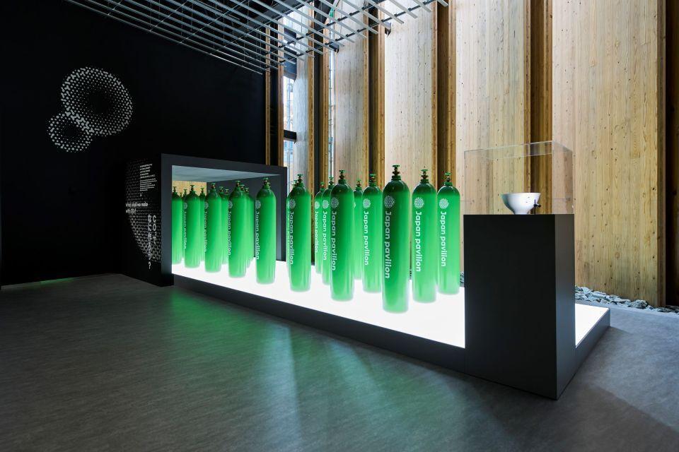 Photo of an exhibit of green gas cylinders used to create biodegradable plastic
