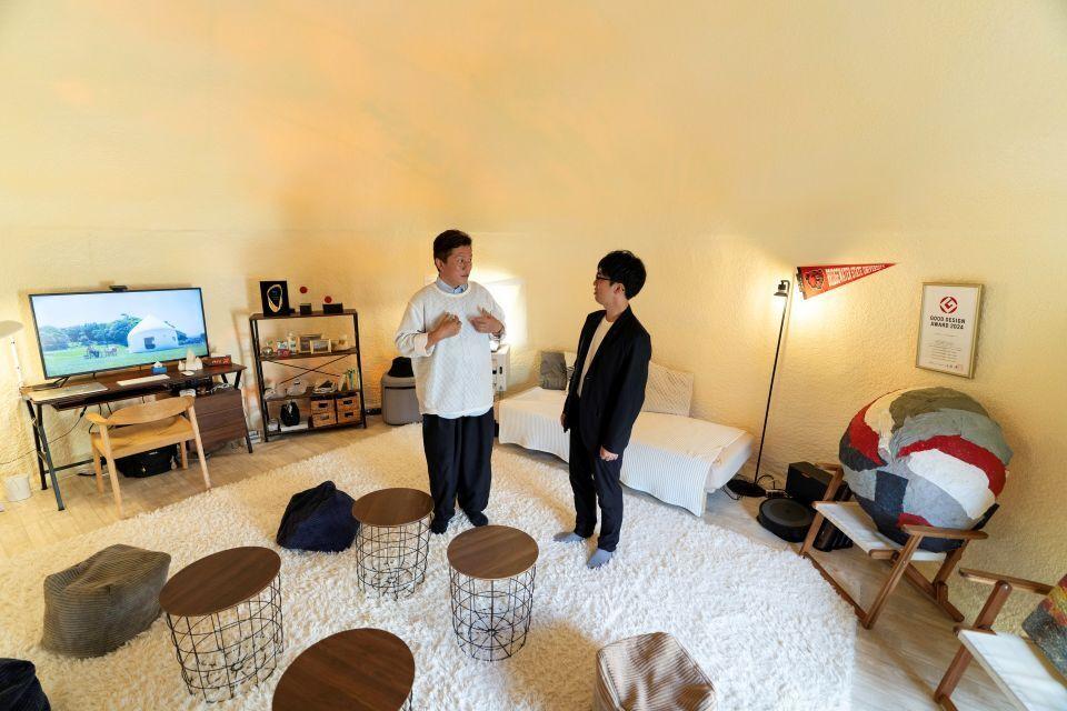 Kitagawa Keisuke and Yamanaka Tsukasa standing inside a furnished Instant House