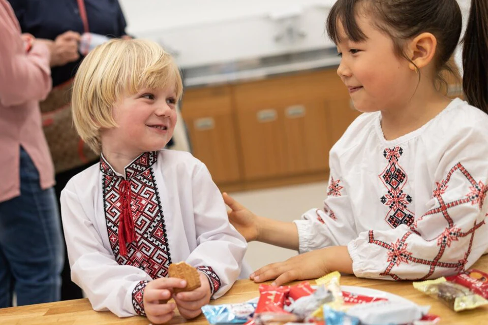 Two children in traditional Ukranian clothing at Sunday School Dzherelze