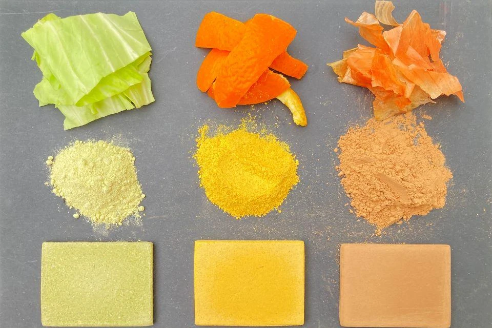A variety of types of food waste, shown as turned into powder and then reconstituted into new materials